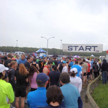 At the start, in a drizzle, freezing cold, although a number of people are dressed in shorts.